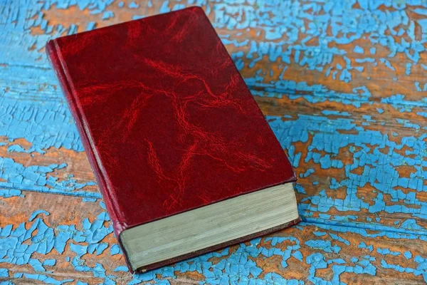 Closed Book Red Cover Lying Blue Brown Worn Table — Stock Photo, Image