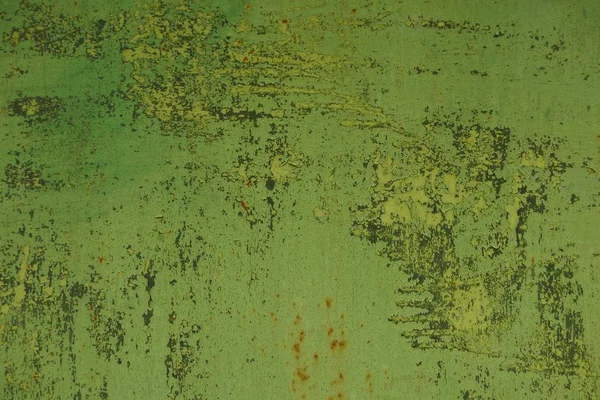 green metal texture from old frayed fence wall