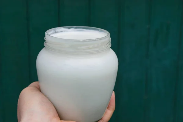 Glass Jar Milk Hand Green Background — Stock Photo, Image