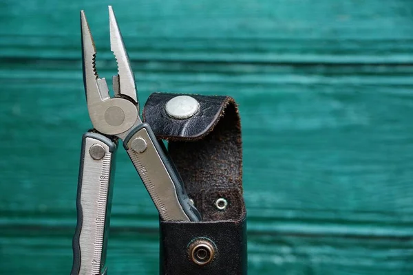 Iron Pliers Leather Case Green Background — Stock Photo, Image