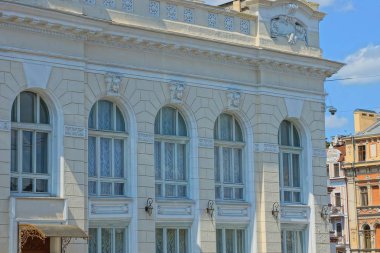 büyük bir binanın beyaz duvarında eski pencereler bir satır