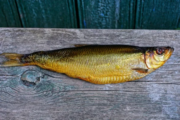 Ein Braun Geräucherter Heringsfisch Liegt Auf Einem Grauen Holzbrett — Stockfoto