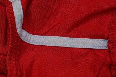 Beyaz çizgili buruşuk kıyafetlerin kırmızı kumaşı.