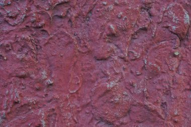 Duvardaki büyük kirli taşın kırmızı arkaplanı.