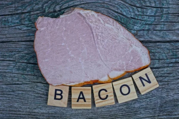 Piece Bacon Meat Word Wooden Letters Gray Table — Stock Photo, Image