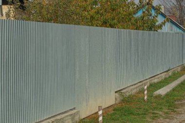 long private gray iron fence outside in the grass