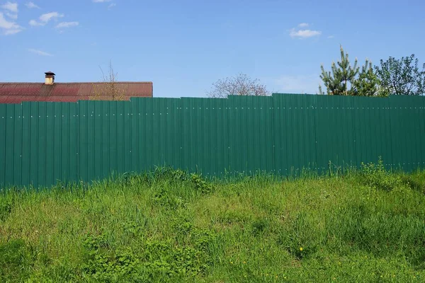 空を背景に緑の金属製の柵の一部が — ストック写真