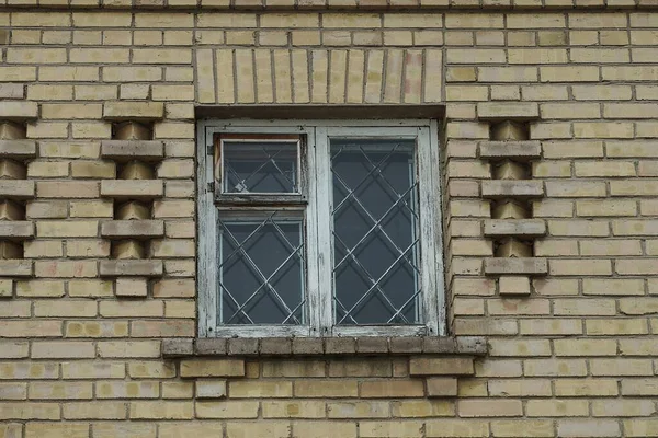 One White Old Wooden Window Iron Bars Brown Brick Wall — Zdjęcie stockowe