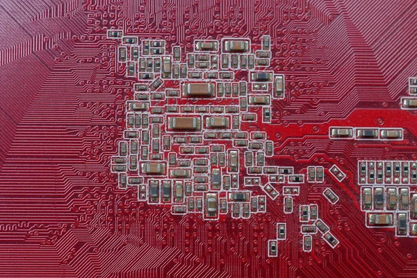 part of a red microcircuit board with small gray details