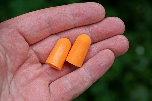 オレンジ色のプラスチック製耳栓・ イヤープラグ写真素材