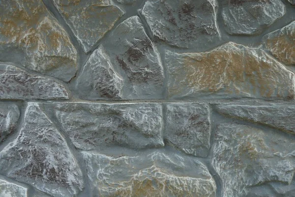 フェンスの壁にある大きな石畳の灰色の茶色の石の質感 — ストック写真