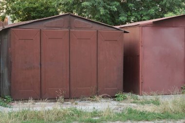 Kapalı kapıları olan kırmızı bir demir garaj.