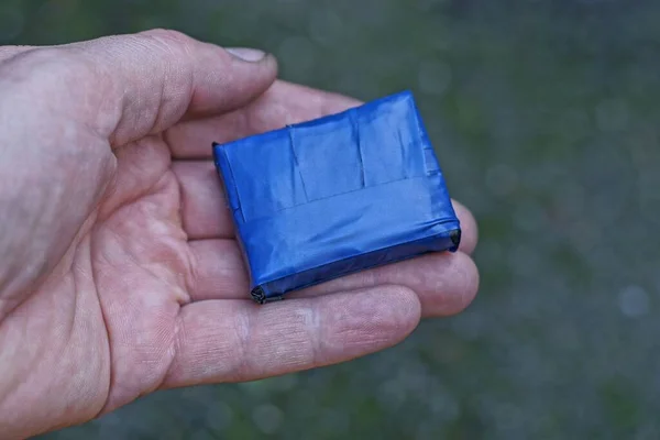 Одна Маленька Коробка Синій Електричній Стрічці Лежить Відкритій Долоні Сірому — стокове фото