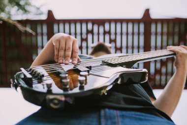 bir bas gitarist ve onun aletleri ile açık fotoğraf oturum
