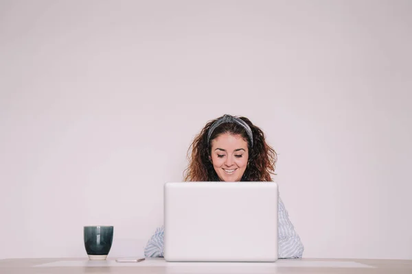 young woman writes something on her laptop