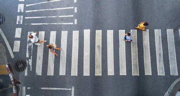 Aerial photo top view of people walk on street in the city over pedestrian crossing traffic road