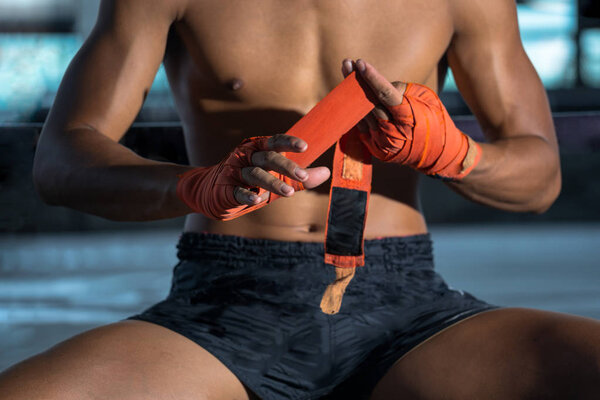 Fighter tying tape before the fight, Thai boxing