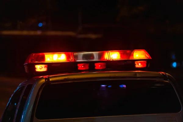 Emergency light, Red light flasher atop of a police car at night