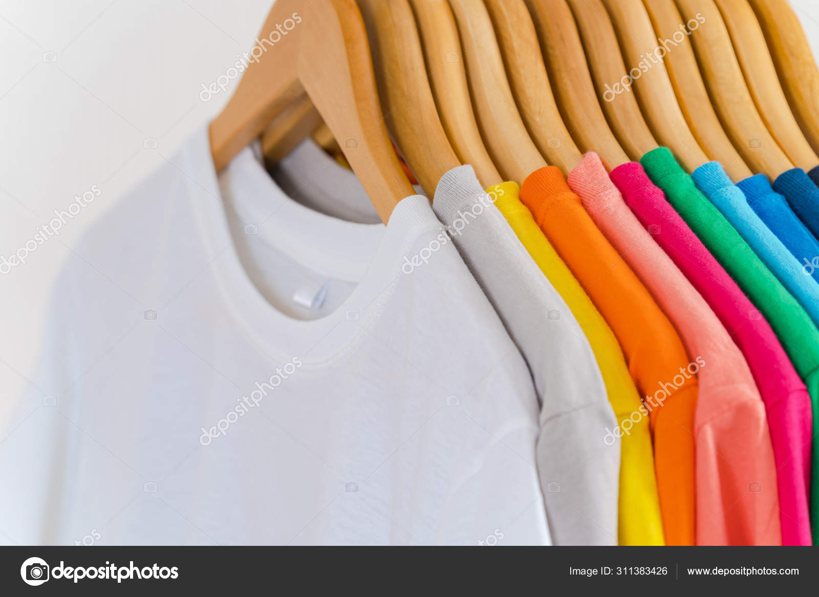 Close up of Colorful t-shirts on hangers, apparel background Stock Photo by  ©Naypong 311383426