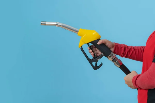 Woman hold fuel nozzle isolated on blue background