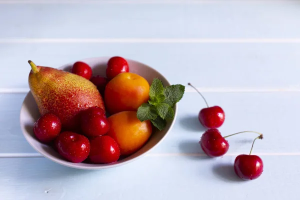 Bir Kasede Meyve Kırmızı Kiraz Kayısı Beyaz Bir Kapta Taze — Stok fotoğraf