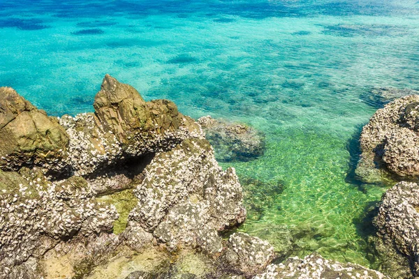 Tropical island rock on the beach with blue sky. Koh kham pattay