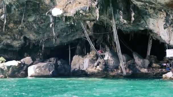 Caverna rochosa perto de água azul cristal — Vídeo de Stock