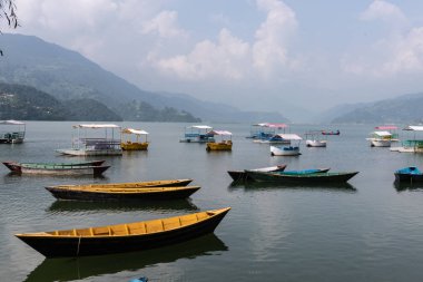 Phewa Gölü Bulutlu Bir Gün ve ahşap renkli Tekneler
