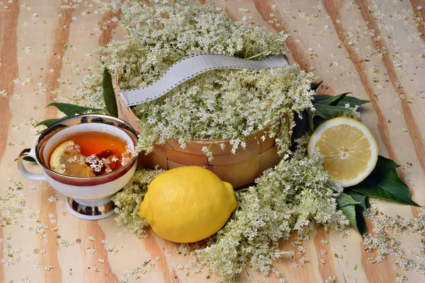 Health tea from elderberry flowers on a wooden table