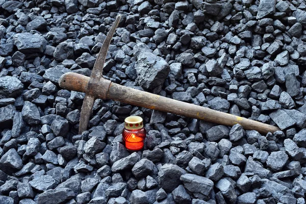 Vigil light, candle with the miner pickaxe after the fatal accident in the mine