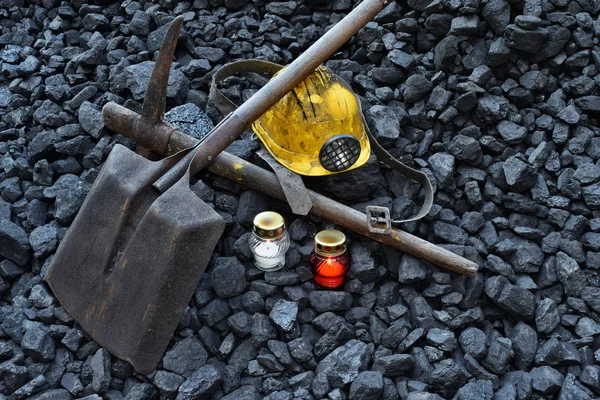 Vigil light, candle with the miner belongings (helmet, pickaxe, shovel, belt) after the fatal accident in the mine