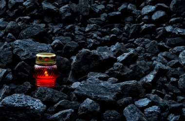 Vigil light, candle on cheap of coal after the fatal accident in the mine clipart