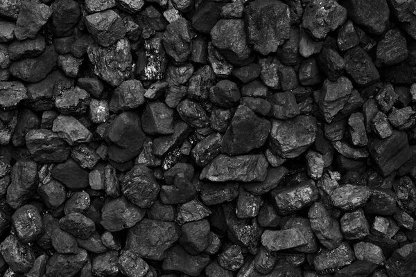 A heap of black natural coal, photo of coal mine background, texture