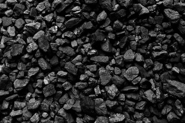 A heap of black natural coal, photo of coal mine background, texture