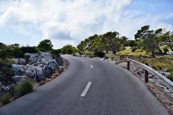 Open coastal road winding through to lighthouse Cap Formentor, Mallorca, Spain