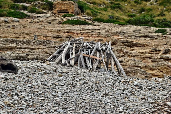 Primitive a hut shelter in the woods made of a fallen branches in Cala Figuera, Mallorca