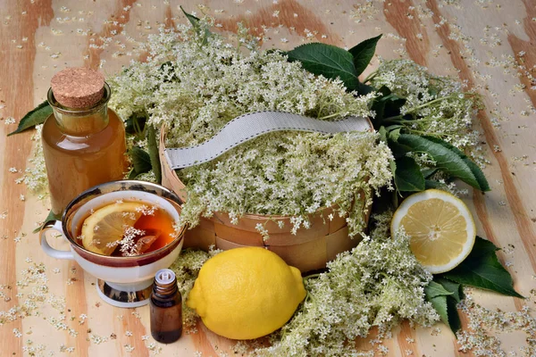 Health tea with lemon from elderberry flowers on a wooden table