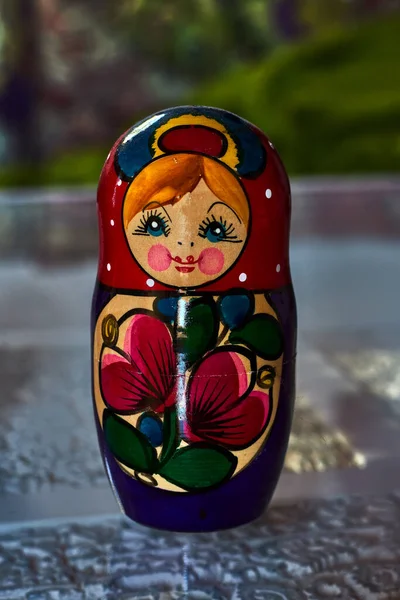 Close-up of a traditional Russian doll, in vivid colors and blue eyes