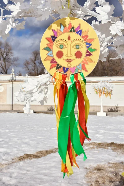 emblem of the sun with colorful ribbons on the branches, sun pic