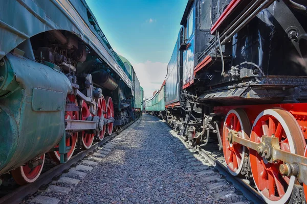 between wagons of old trains, between two old trains, red metal