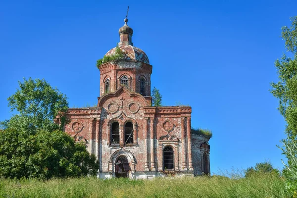 Old brick abandoned orthodox Church of the Trinity Church. abandoned Trinity Church in the village of Zasechnoye. abandoned red brick church in the thicket, abandoned temple in the field