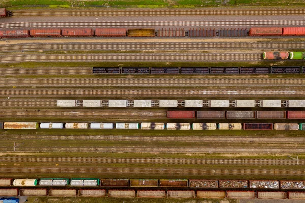 Vista aérea de trenes de carga de colores con mercancías en la estación de tren . — Foto de Stock