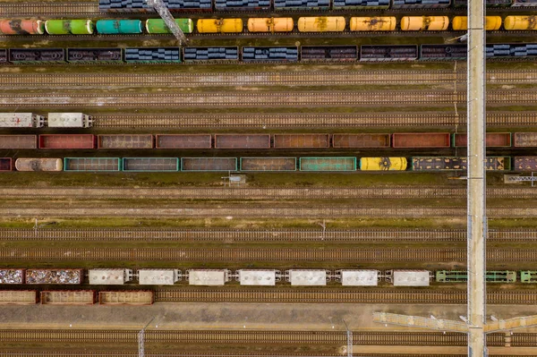 Vista aérea de trenes de carga de colores con mercancías en la estación de tren . — Foto de Stock