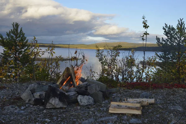 Camp fire in sweden on a lake in autumn