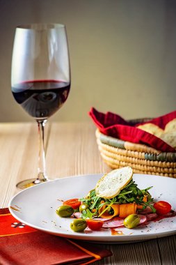 Bir bardak kırmızı şarap vegan sebze salatası ile
