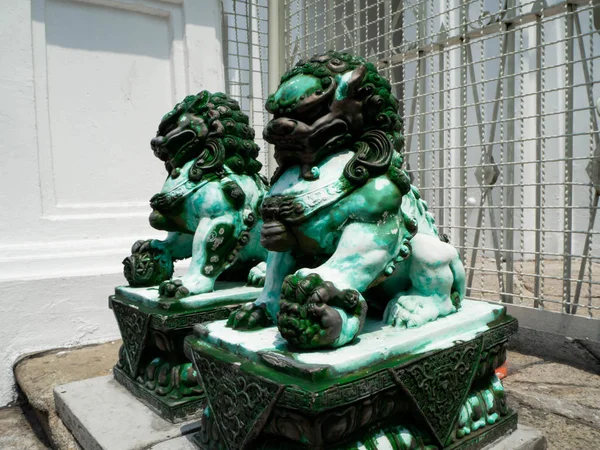 The stone lion statue is  green jade
