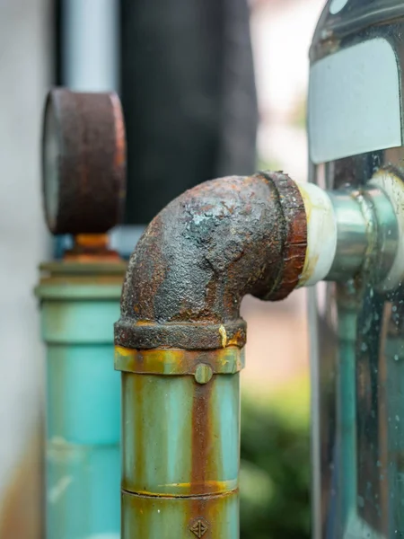 Rusty pipes of water pump,Out door, After many years of operation corroded metal pipe was destroyed