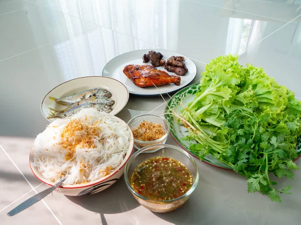 Thai food name is Maing PLA-too or salad fried fish,Street food in Bangkok,Include grilled Chicken Grilled liver Grilled heart Rice Vermicelli Fried fish Lettuce and coriander,Healthy for body
