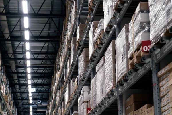 The warehouse full of goods, boxes and shelves in order
