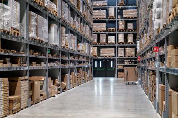 The warehouse full of goods, boxes and shelves in order